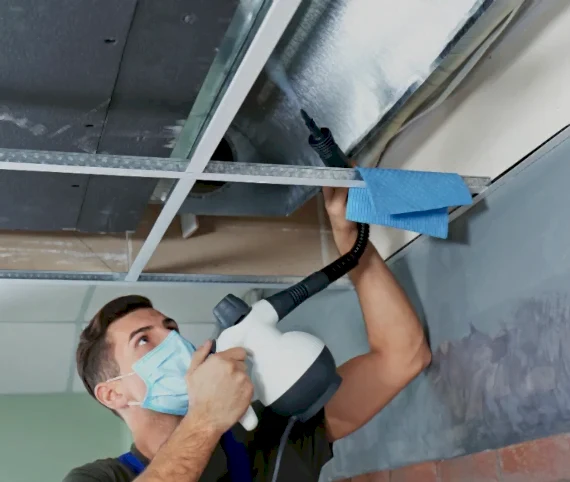 Technician sanitizing an open air duct during air duct cleaning in Chantilly, VA