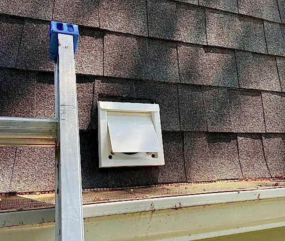 Dryer vent roof termination on an asphalt shingle roof
